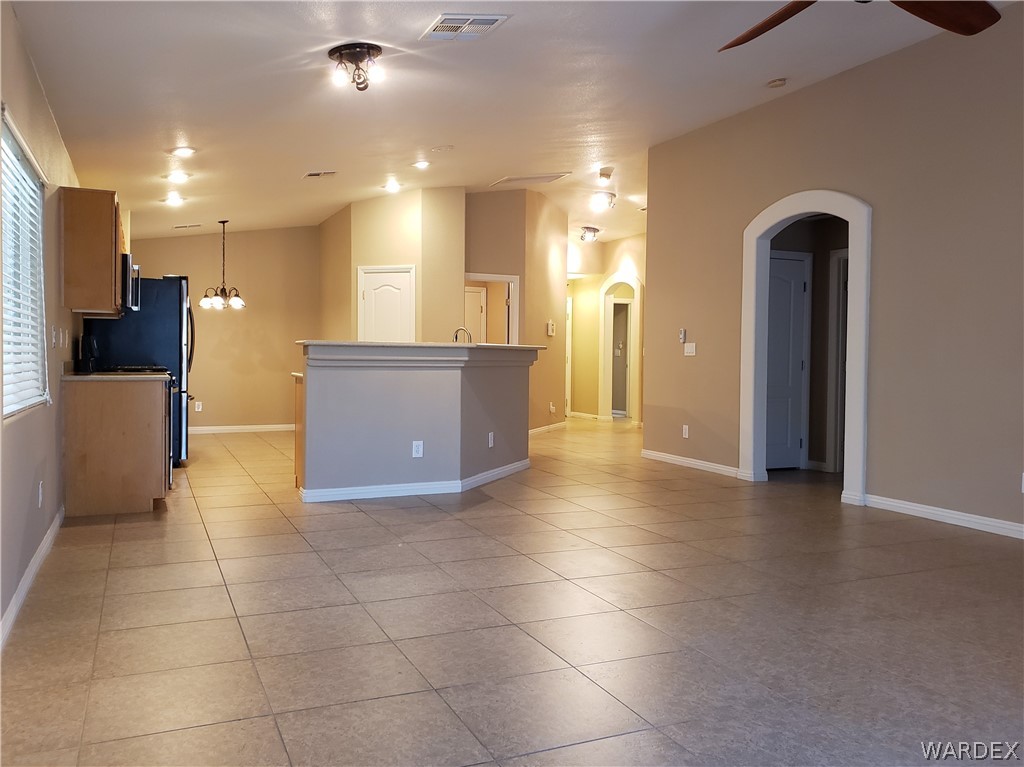 2803 Sunken Ship Street, Unit 89029 Laughlin, NV 89029 - Photo 11 of 35 a view of a kitchen with a refrigerator and a stove