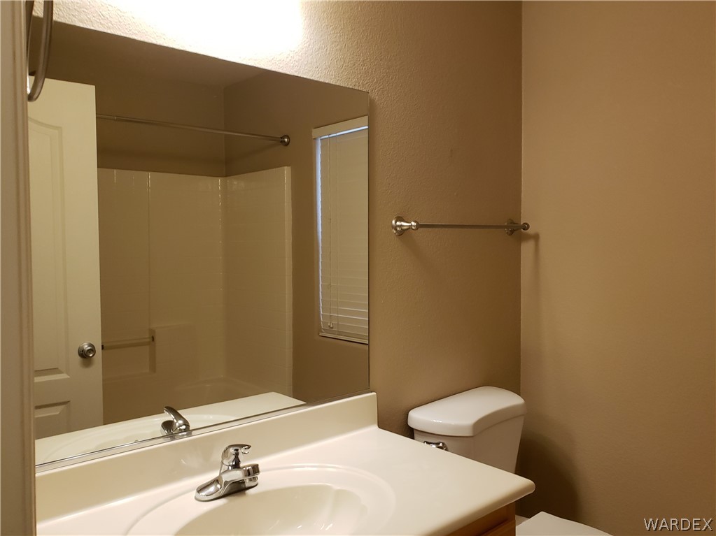 2803 Sunken Ship Street, Unit 89029 Laughlin, NV 89029 - Photo 14 of 35 a bathroom with a sink a toilet and shower