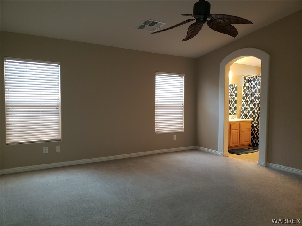 2803 Sunken Ship Street, Unit 89029 Laughlin, NV 89029 - Photo 18 of 35 an empty room with windows and chandelier fan