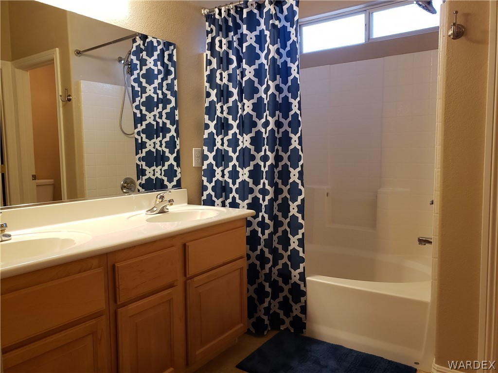 2803 Sunken Ship Street, Unit 89029 Laughlin, NV 89029 - Photo 23 of 35 a bathroom with a bathtub and shower