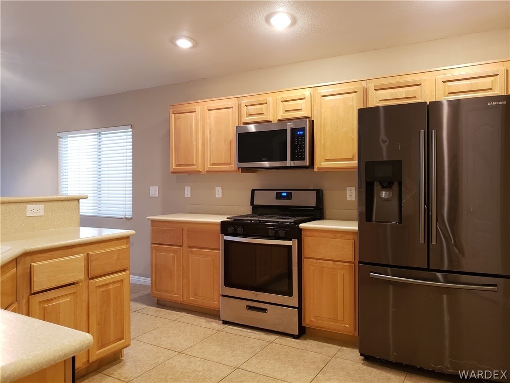 2803 Sunken Ship Street, Unit 89029 Laughlin, NV 89029 - Photo 5 of 35 a kitchen with a refrigerator stove and microwave