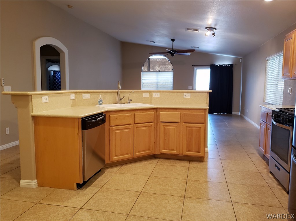 2803 Sunken Ship Street, Unit 89029 Laughlin, NV 89029 - Photo 7 of 35 a kitchen with a sink a stove top oven and cabinets