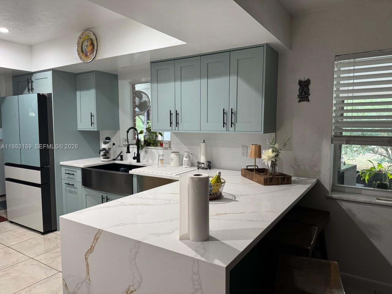1221 Southwest Stakes Street Arcadia, FL 34266 - Photo 13 of 19 a kitchen with a sink dishwasher a stove and white cabinets with wooden floor