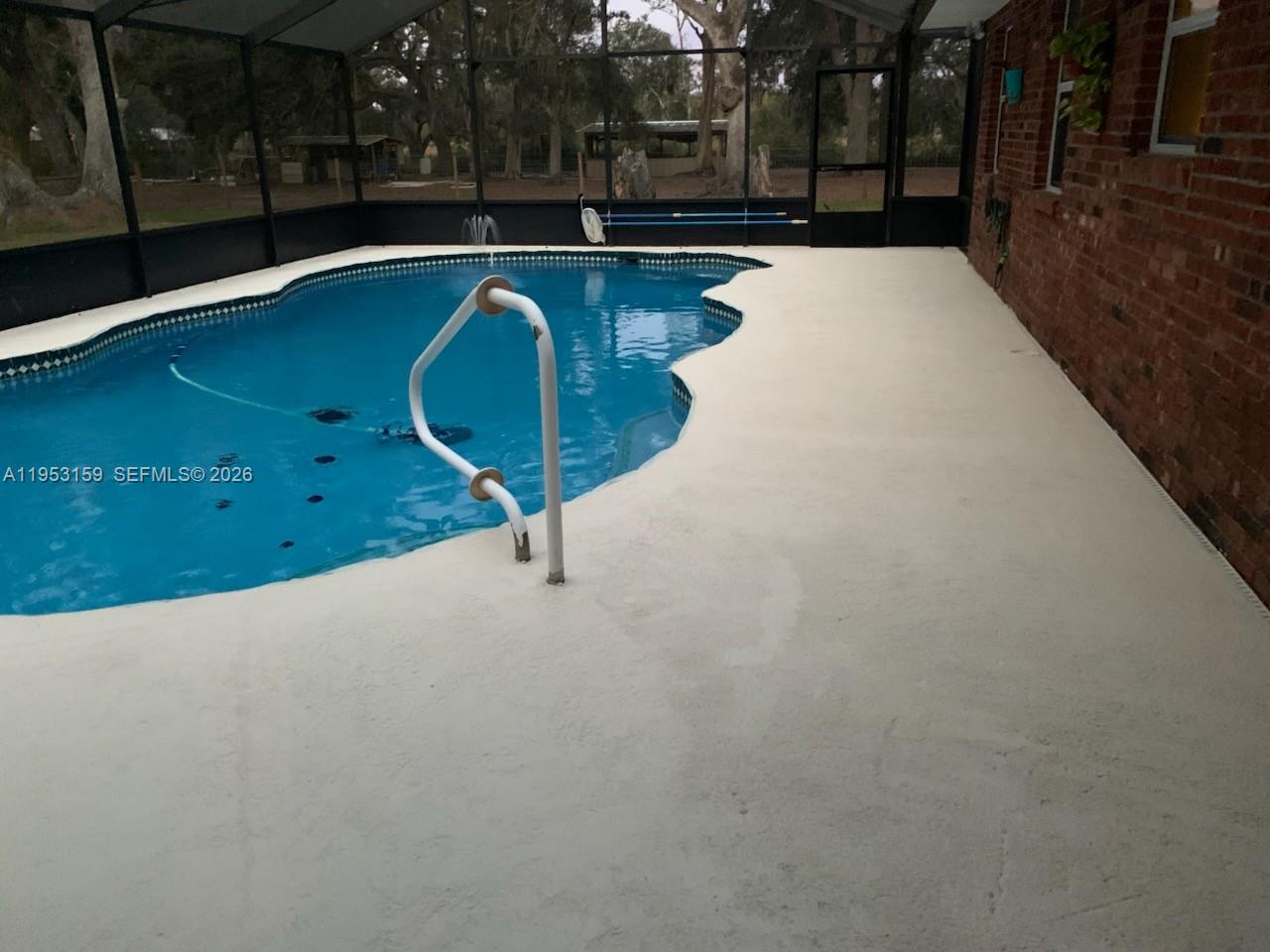 1221 Southwest Stakes Street Arcadia, FL 34266 - Photo 16 of 19 a view of a swimming pool with an outdoor space and seating area