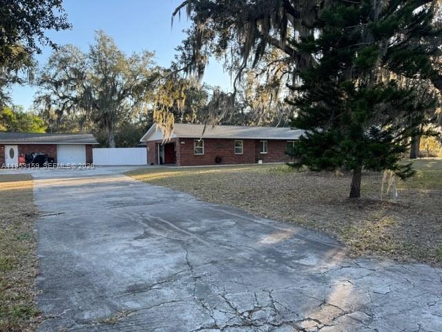1221 Southwest Stakes Street Arcadia, FL 34266 - Photo 17 of 19 a view of large house with a yard and large trees
