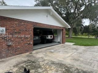 1221 Southwest Stakes Street Arcadia, FL 34266 - Photo 7 of 19 a view of a house with a yard and garage
