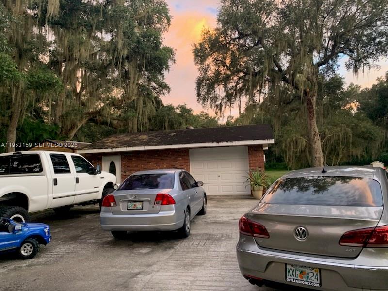 1221 Southwest Stakes Street Arcadia, FL 34266 - Photo 8 of 19 a car parked in parking lot of a house