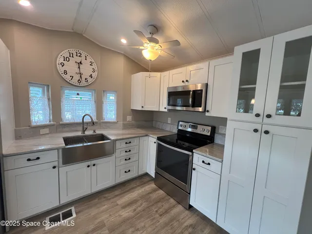 a kitchen with stainless steel appliances a refrigerator sink and cabinets