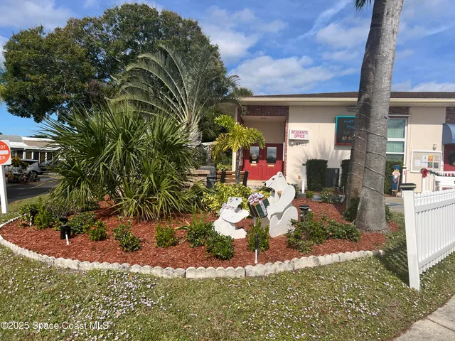 a view of a swimming pool with a lawn chairs and a fire pit