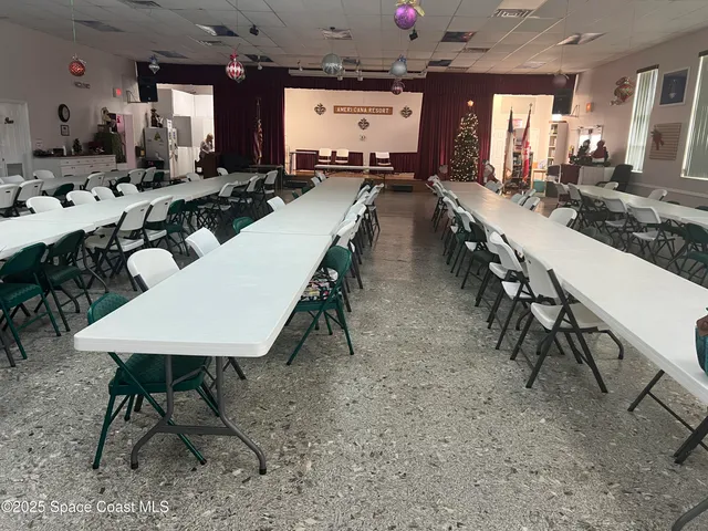 a view of a patio with a table chairs and wooden floor