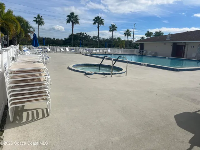 a view of a lake with a yard and large trees