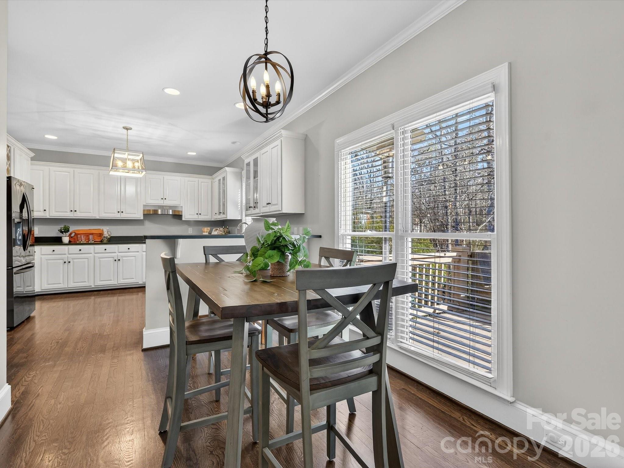 13446 Scanlan Way Davidson, NC 28036 - Photo 17 of 47 a view of a dining room with furniture and a chandelier