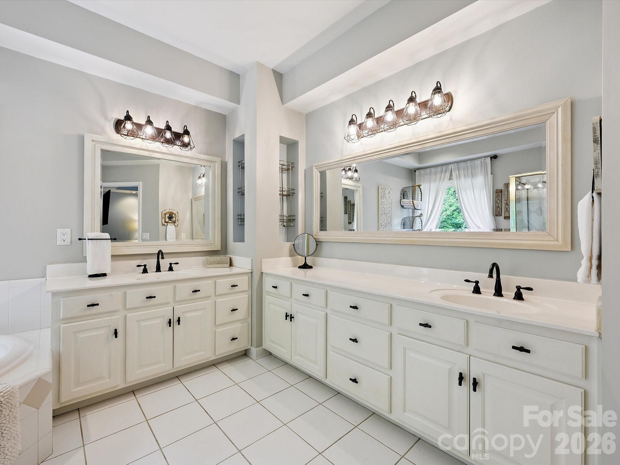 13446 Scanlan Way Davidson, NC 28036 - Photo 29 of 47 a spacious en suite bathroom with double sink a large mirror and a