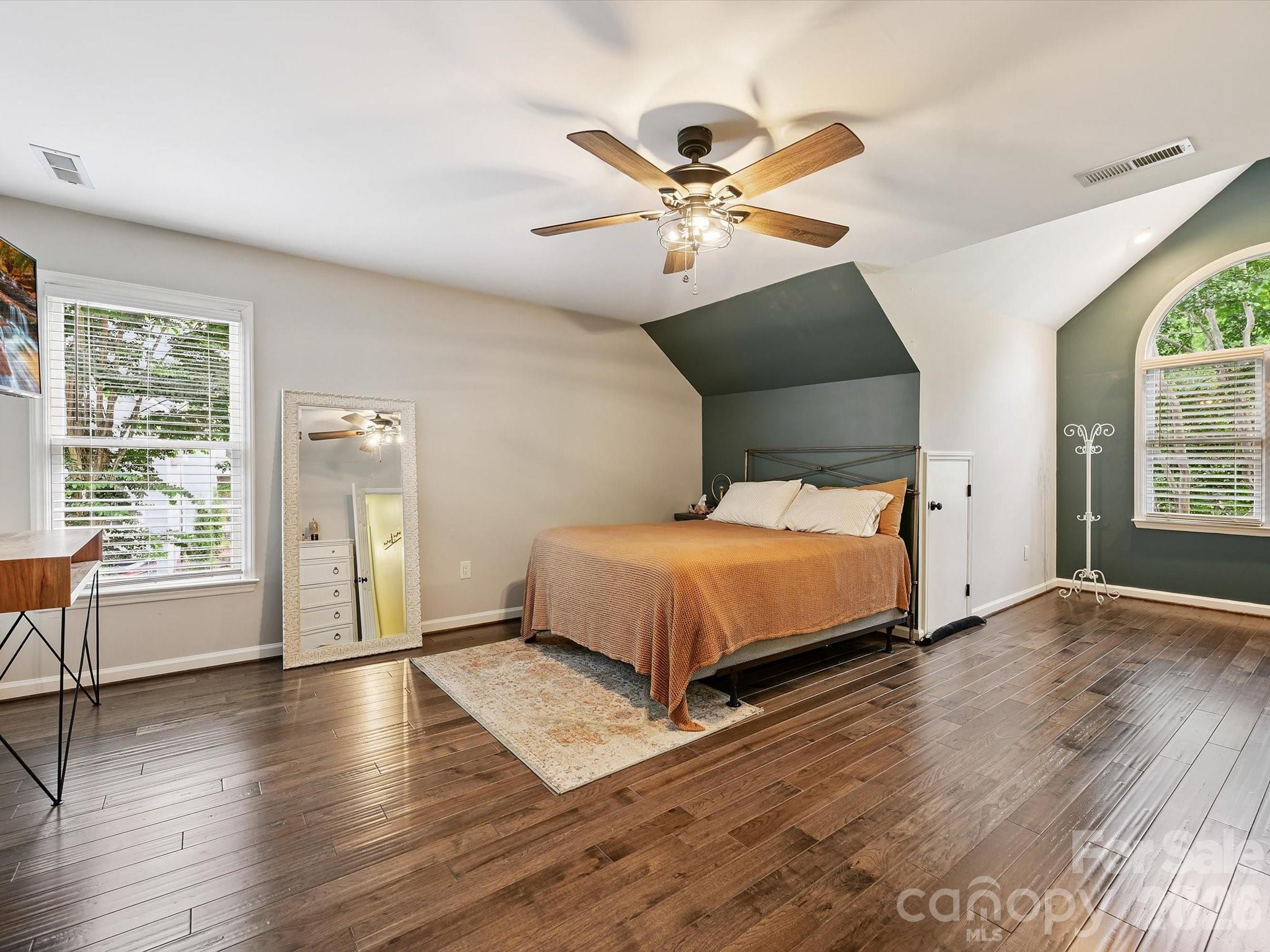 13446 Scanlan Way Davidson, NC 28036 - Photo 33 of 47 a bedroom with a large bed and a chandelier