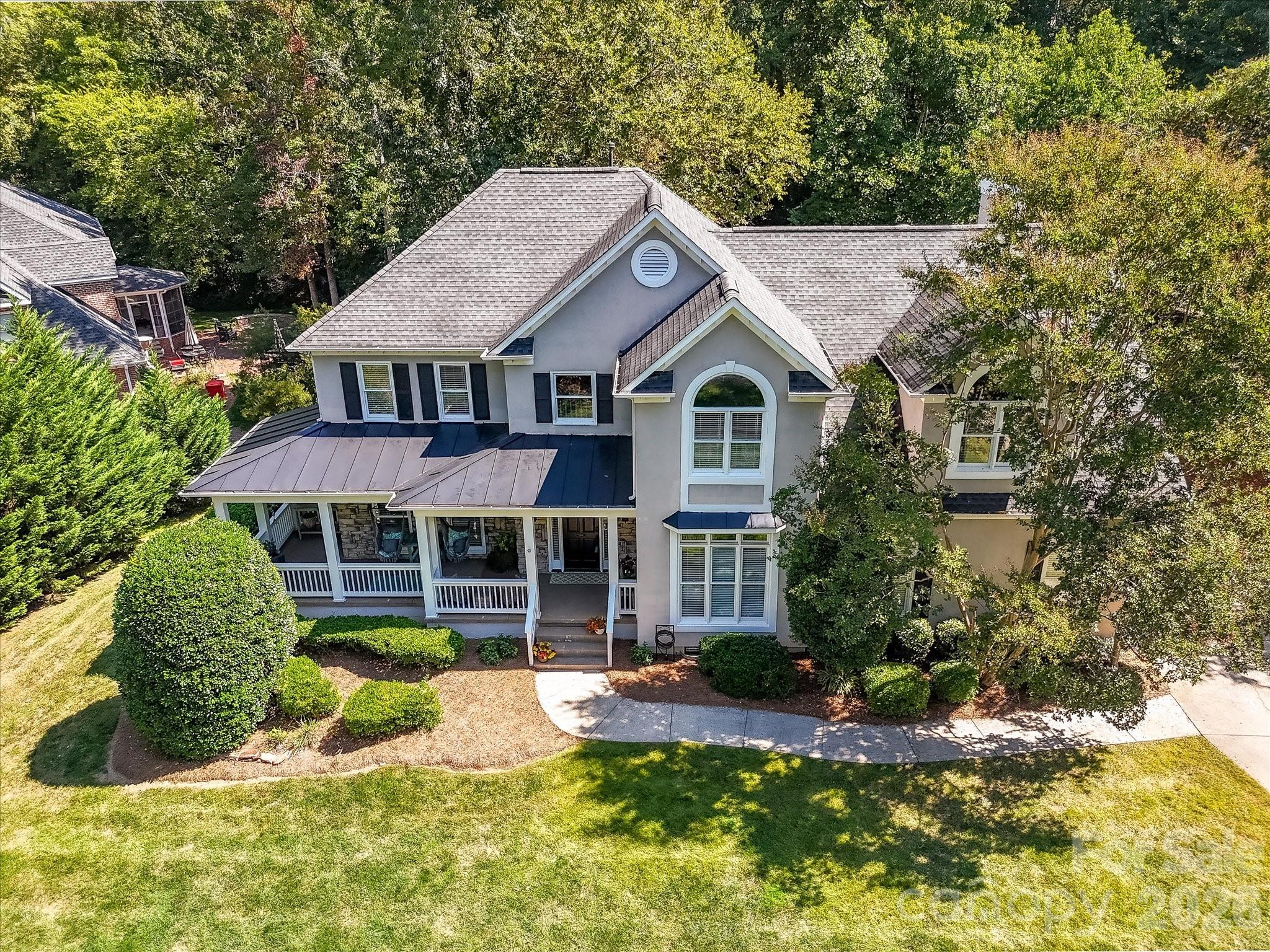 13446 Scanlan Way Davidson, NC 28036 - Photo 4 of 47 a front view of a house with a yard table and chairs