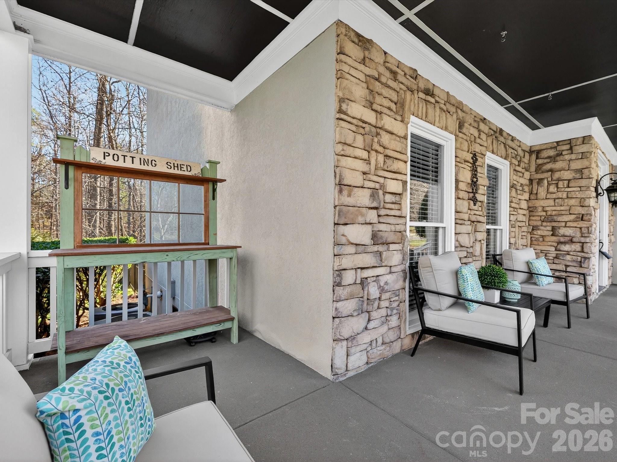 13446 Scanlan Way Davidson, NC 28036 - Photo 7 of 47 a balcony with furniture and a potted plant