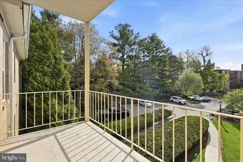 a balcony with trees in front of it