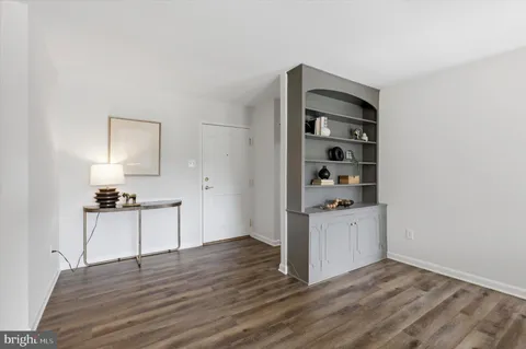 a kitchen with stainless steel appliances a stove and wooden floor