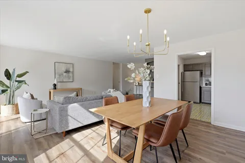 a view of a dining room with furniture and wooden floor