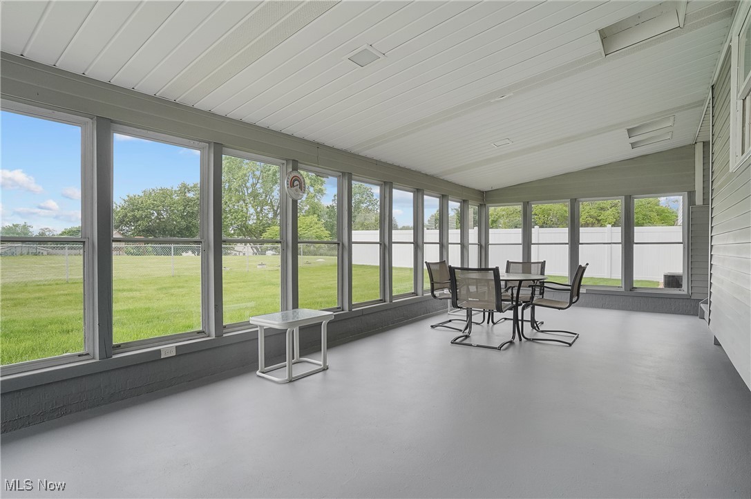 3262 Wright Road Northwest Uniontown, OH 44685 - Photo 20 of 37 Sunroom / solarium featuring plenty of natural light, lofted ceiling, and outdoor dining space