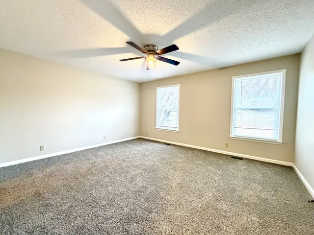 a view of a hallway with wooden floor and stairs