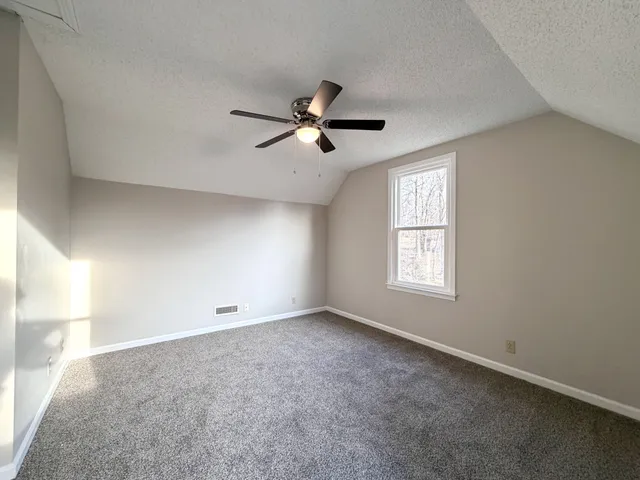 a view of a room with wooden walls