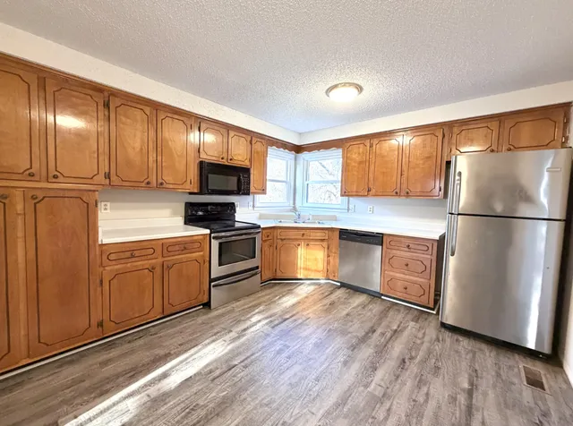 a view of a livingroom with wooden floor and a window