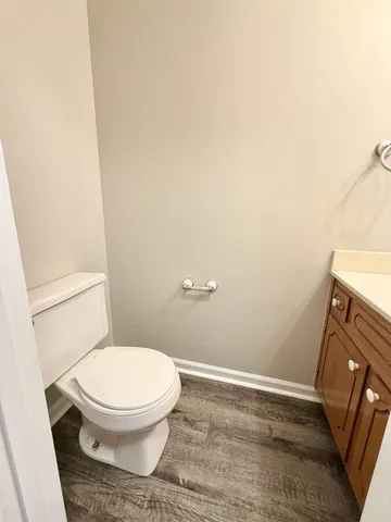 a spacious bathroom with a granite countertop toilet sink and a mirror