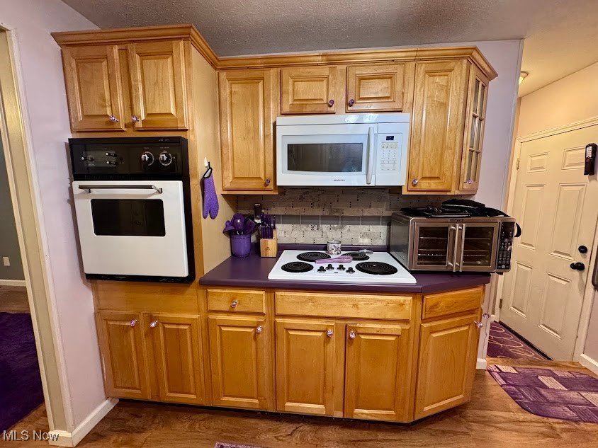 240 Spring Creek Road Northfield, OH 44067 - Photo 5 of 39 Kitchen with decorative backsplash, white appliances, and a textured ceiling