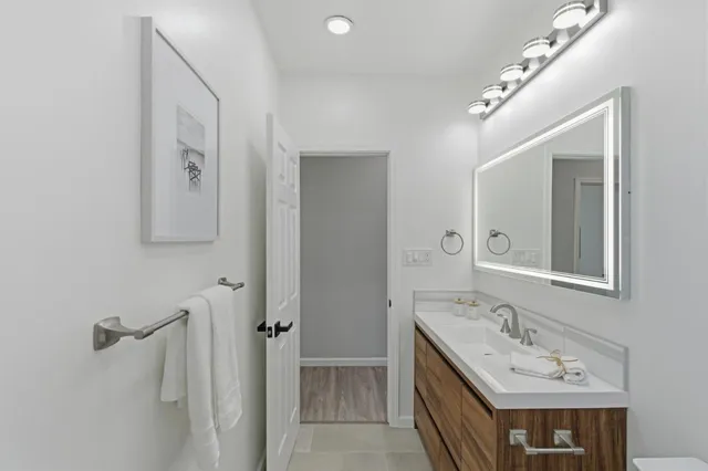 a bathroom with a double vanity sink and mirror with shower