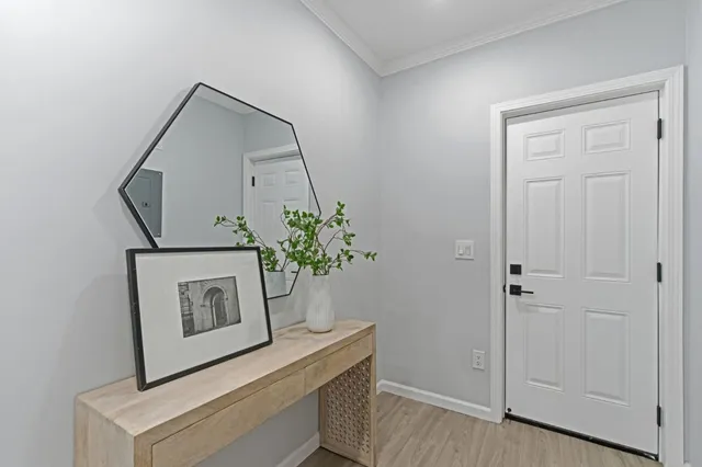 a view of hallway with paintings on the wall