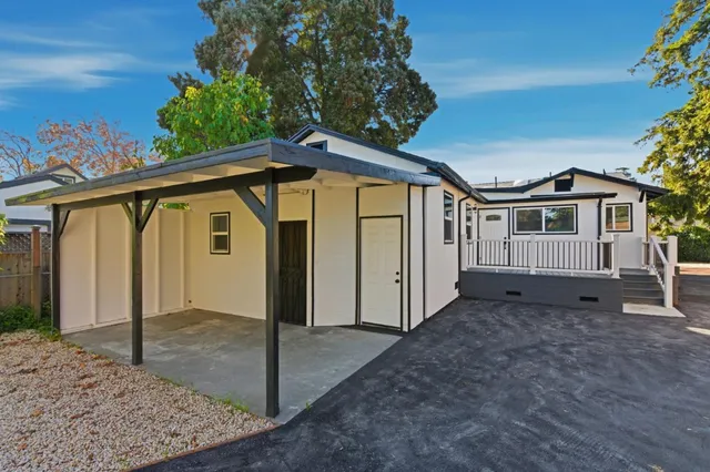 a view of a house with a wooden fence