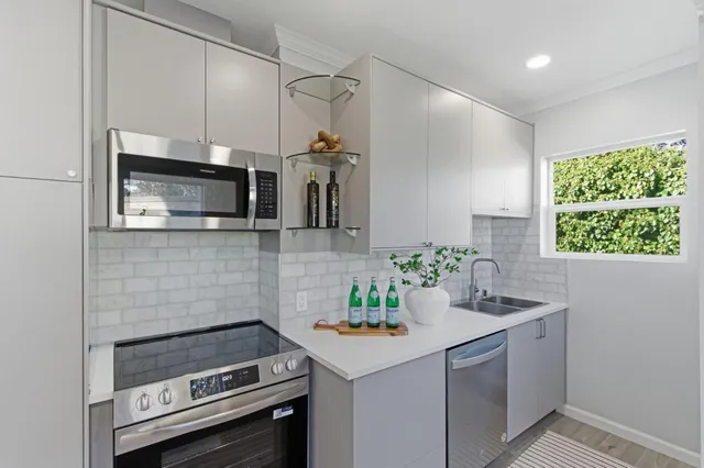 a kitchen with a sink appliances and cabinets
