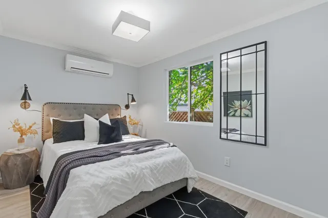 a bedroom with a bed and a window