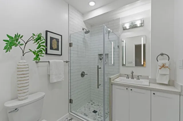a bathroom with a shower sink and mirror