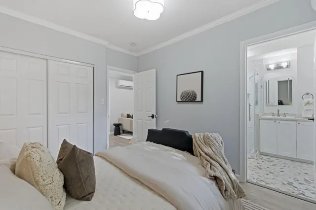 a bedroom with a bed and a couch