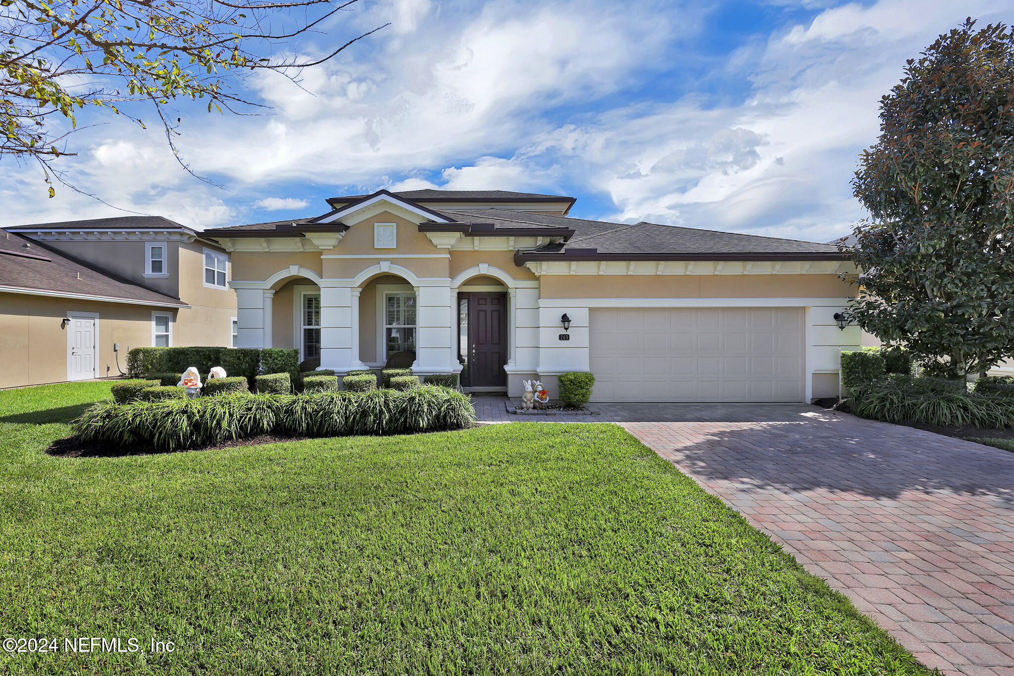 a front view of a house with a yard and garage