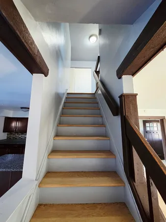 a bathroom with a bathtub shower sink vanity mirror and toilet