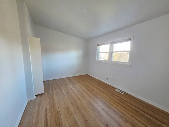 an empty room with white walls and tiles