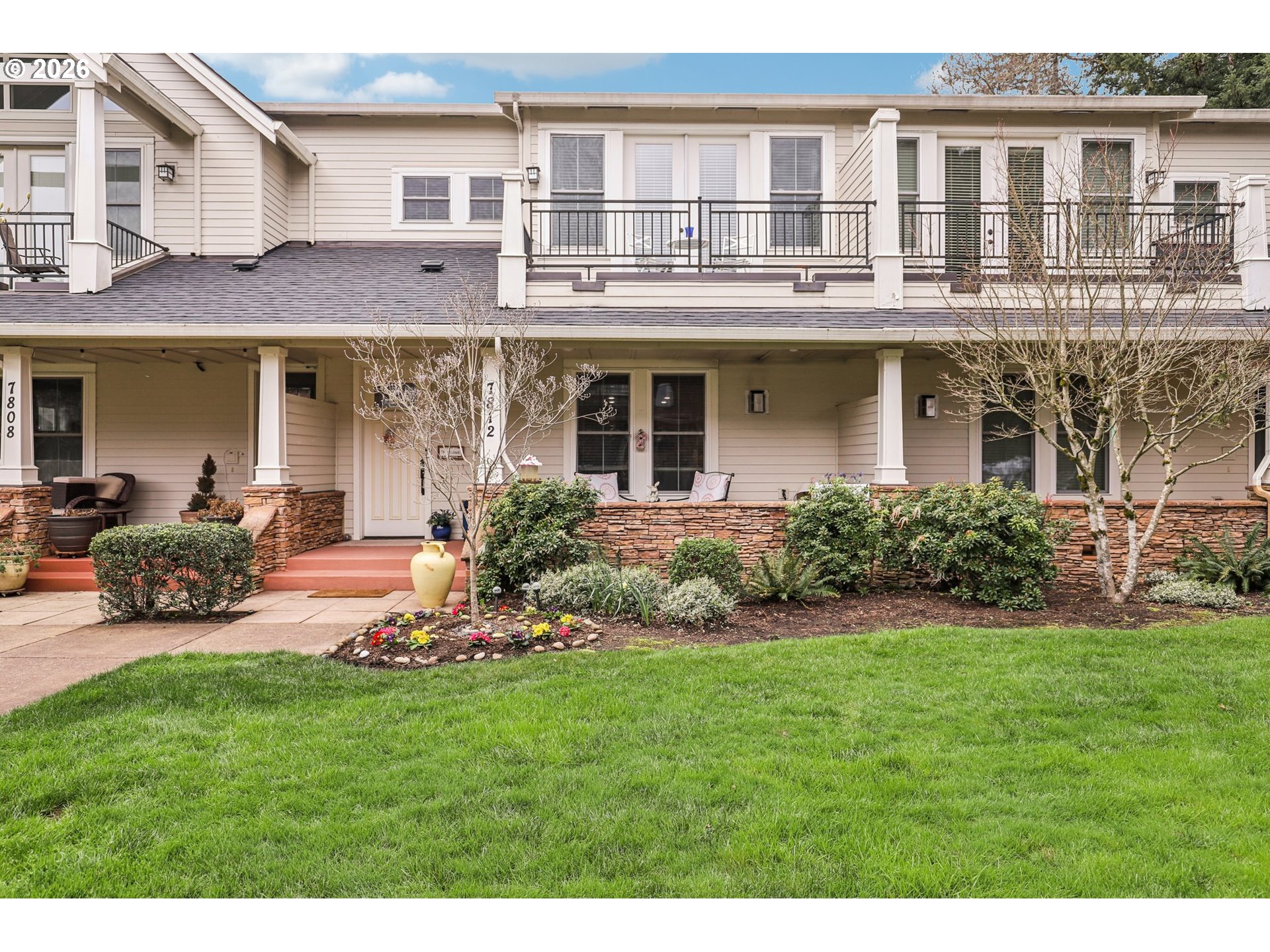 a front view of a house with a garden and patio