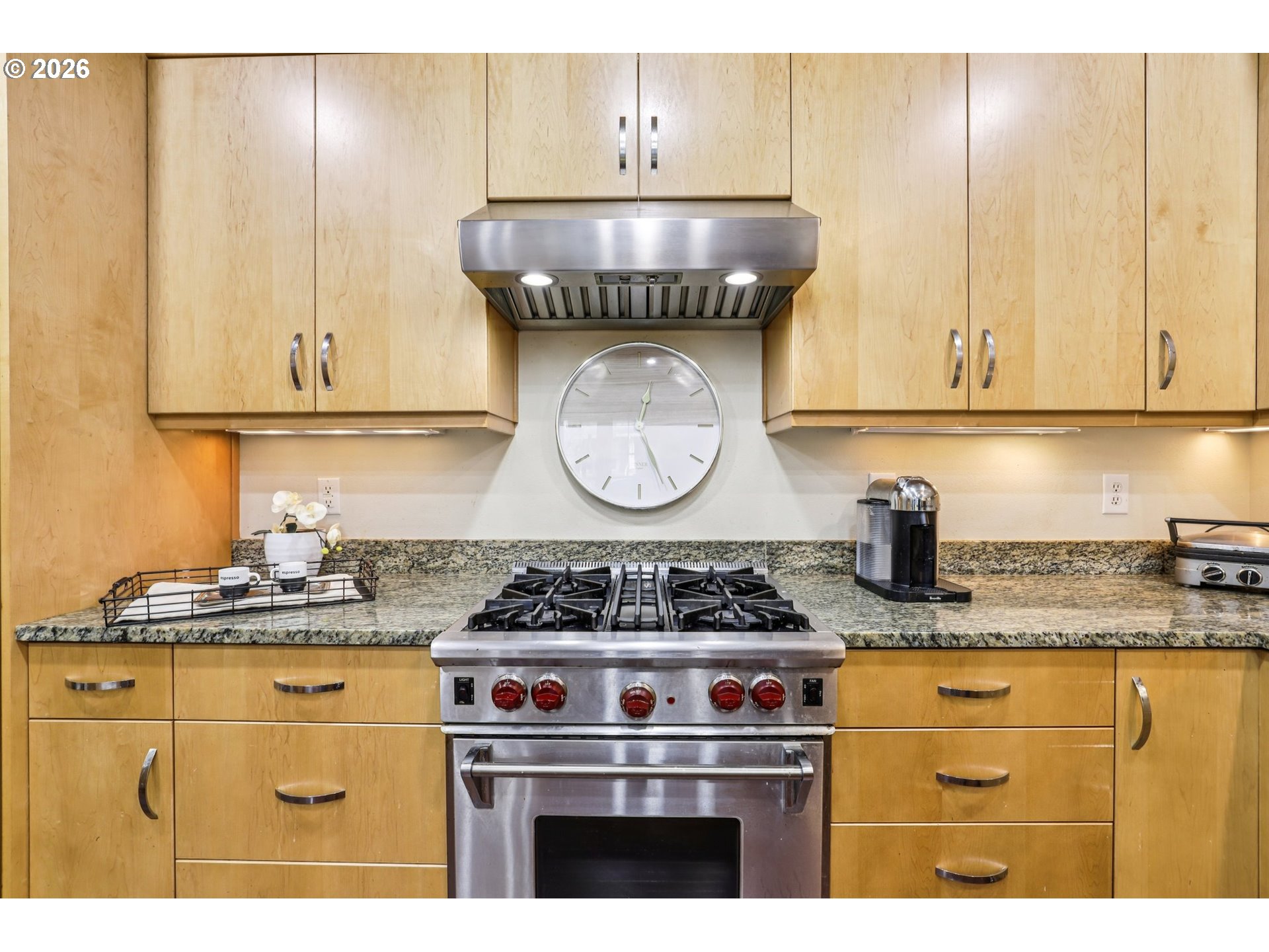 7812 Northwest Quinault Street Camas, WA 98607 - Photo 14 of 48 a kitchen with granite countertop a stove a sink dishwasher and cabinets with wooden floor