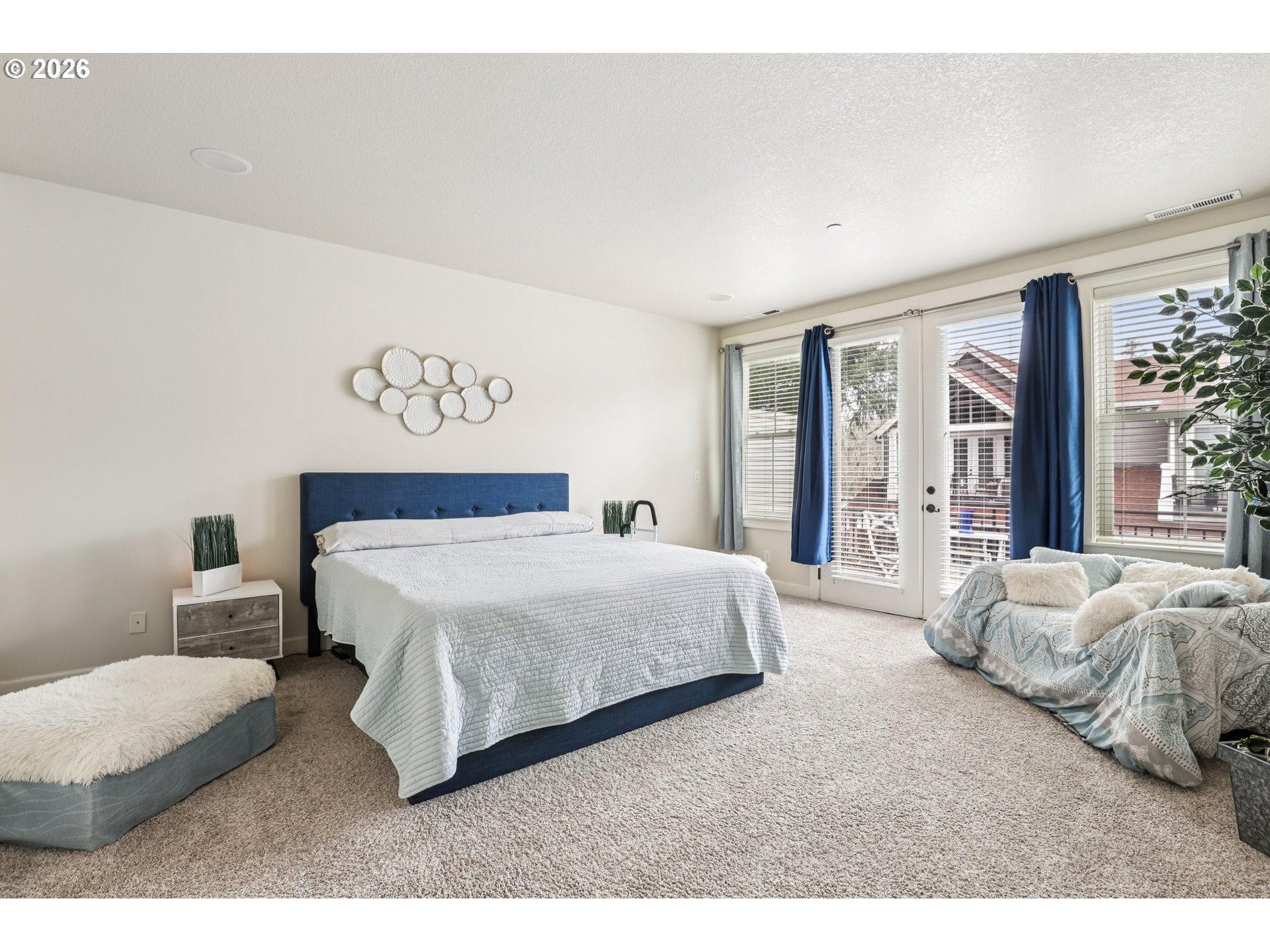 7812 Northwest Quinault Street Camas, WA 98607 - Photo 22 of 48 a spacious bedroom with a bed a couch and a large window