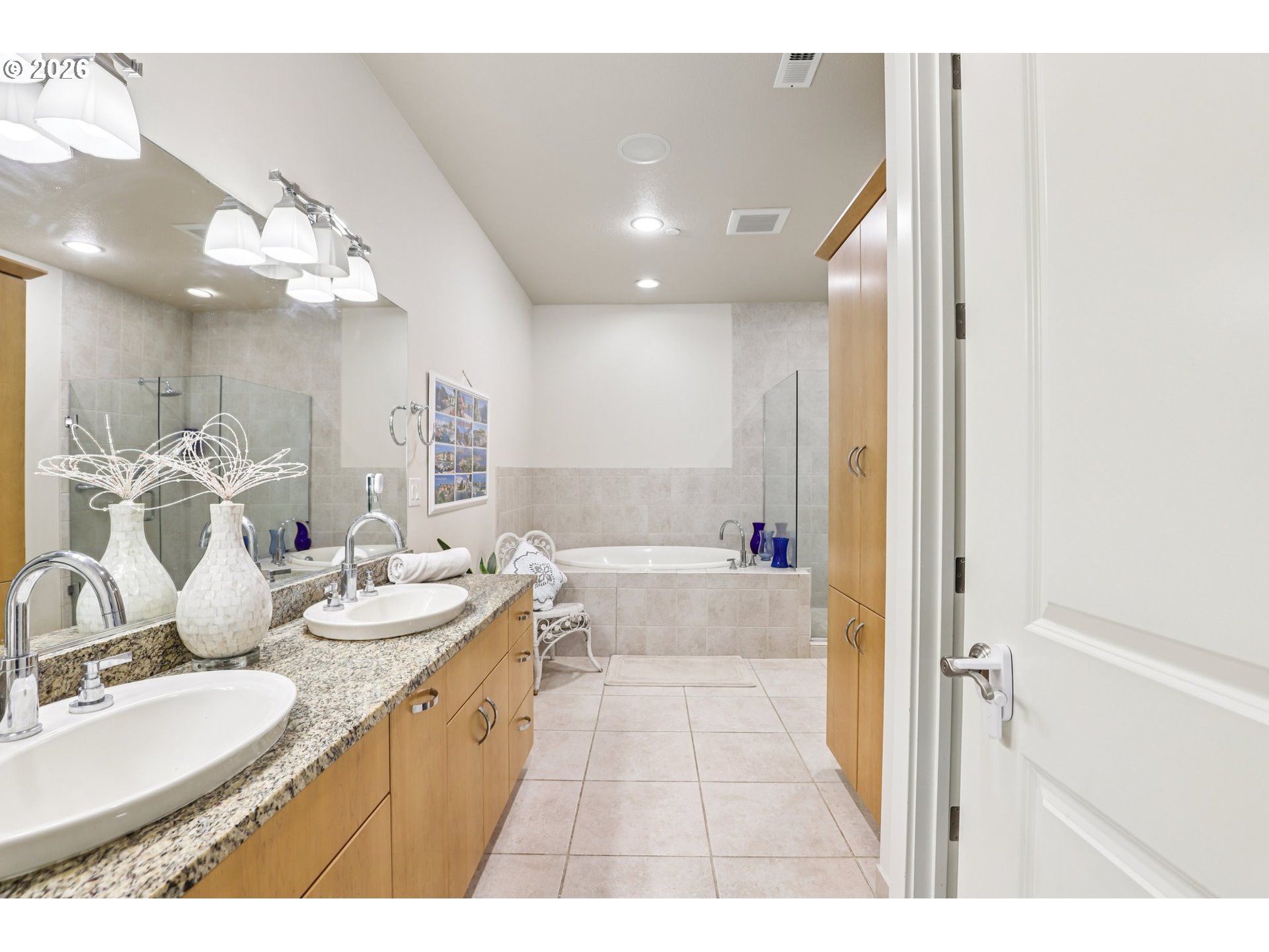 7812 Northwest Quinault Street Camas, WA 98607 - Photo 24 of 48 a bathroom with a double vanity sink a mirror and a bathtub