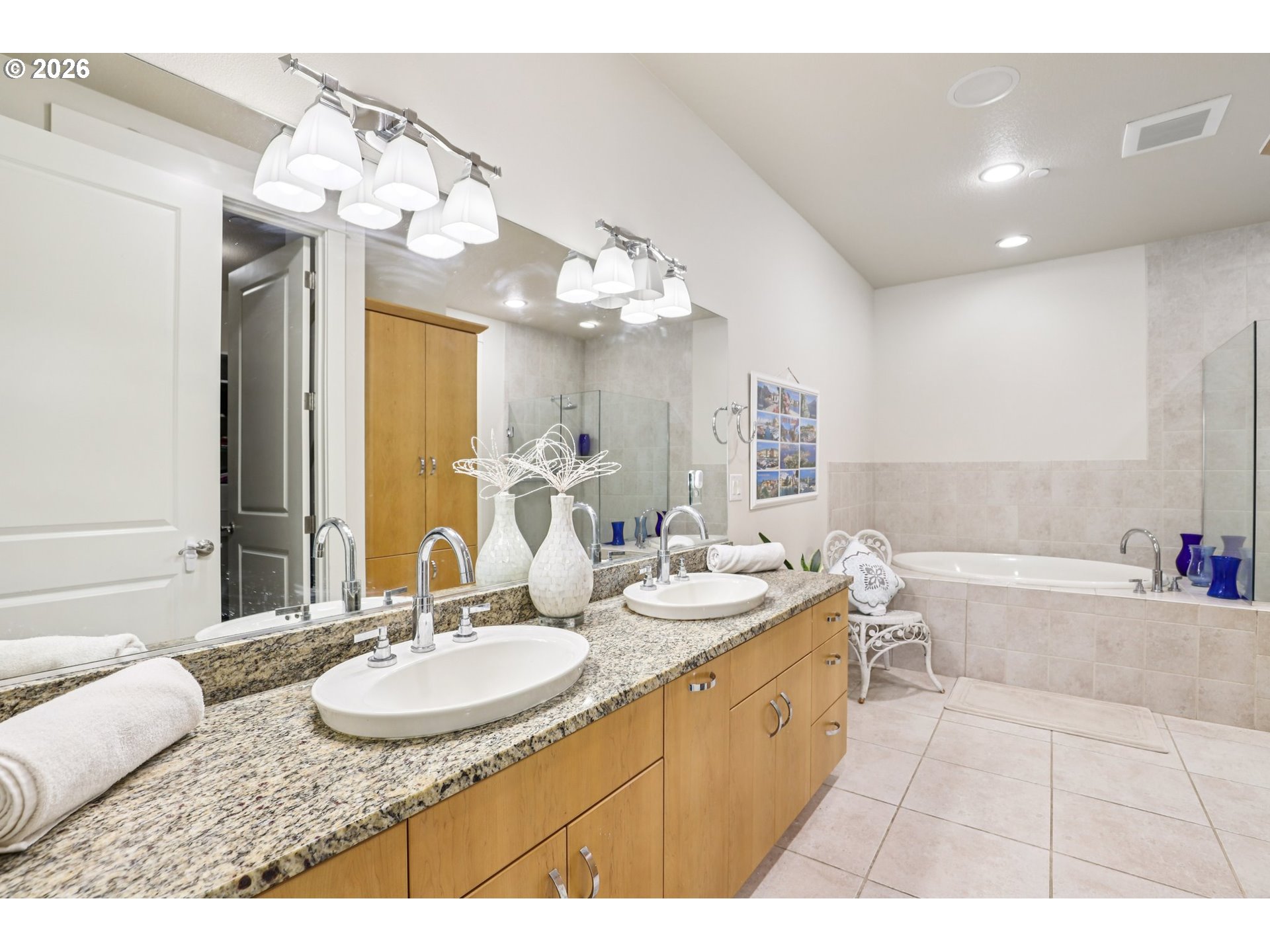 7812 Northwest Quinault Street Camas, WA 98607 - Photo 25 of 48 a spacious bathroom with a granite countertop sink a mirror and a bathtub