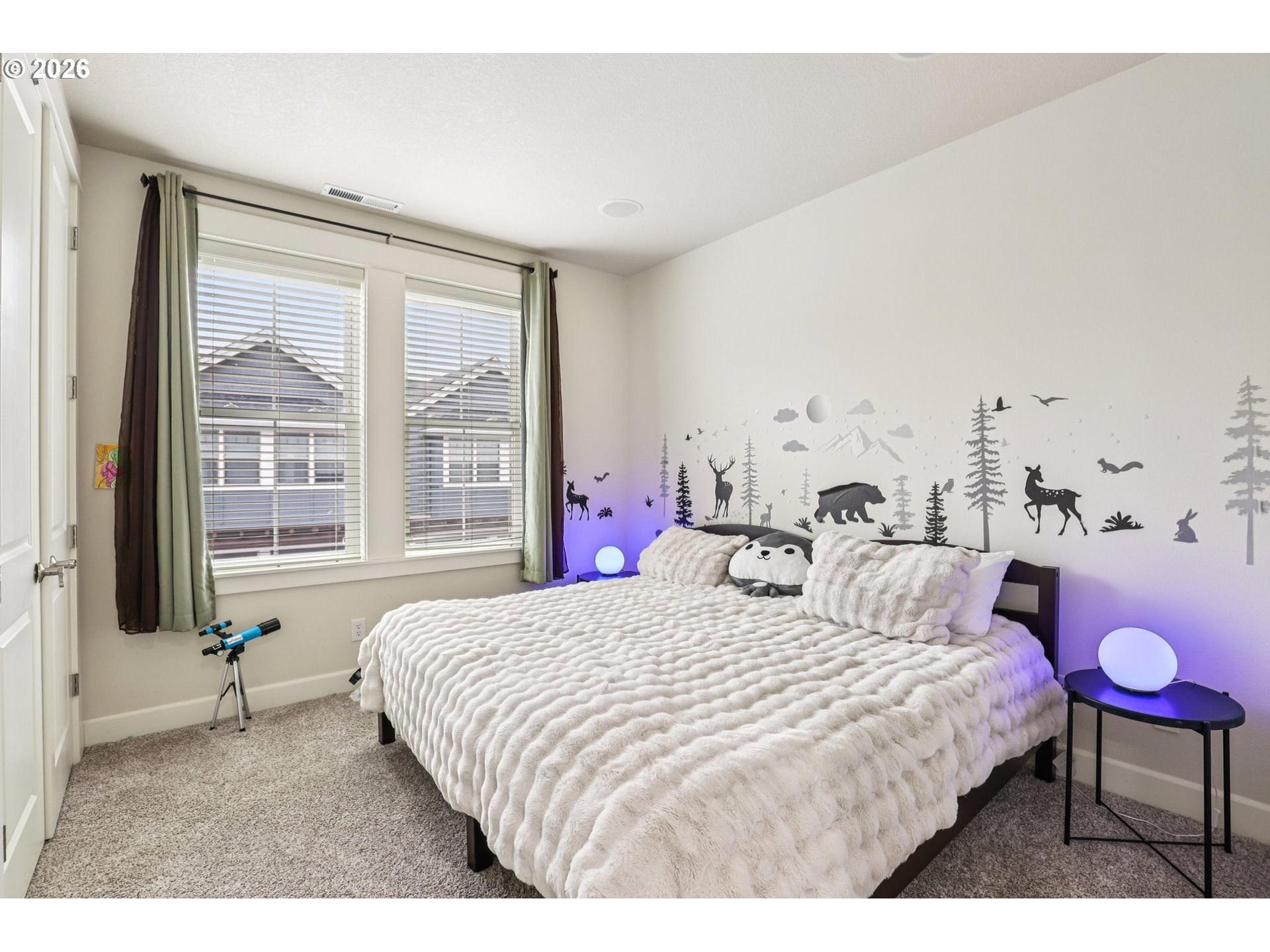 7812 Northwest Quinault Street Camas, WA 98607 - Photo 32 of 48 a bedroom with a bed and a chandelier