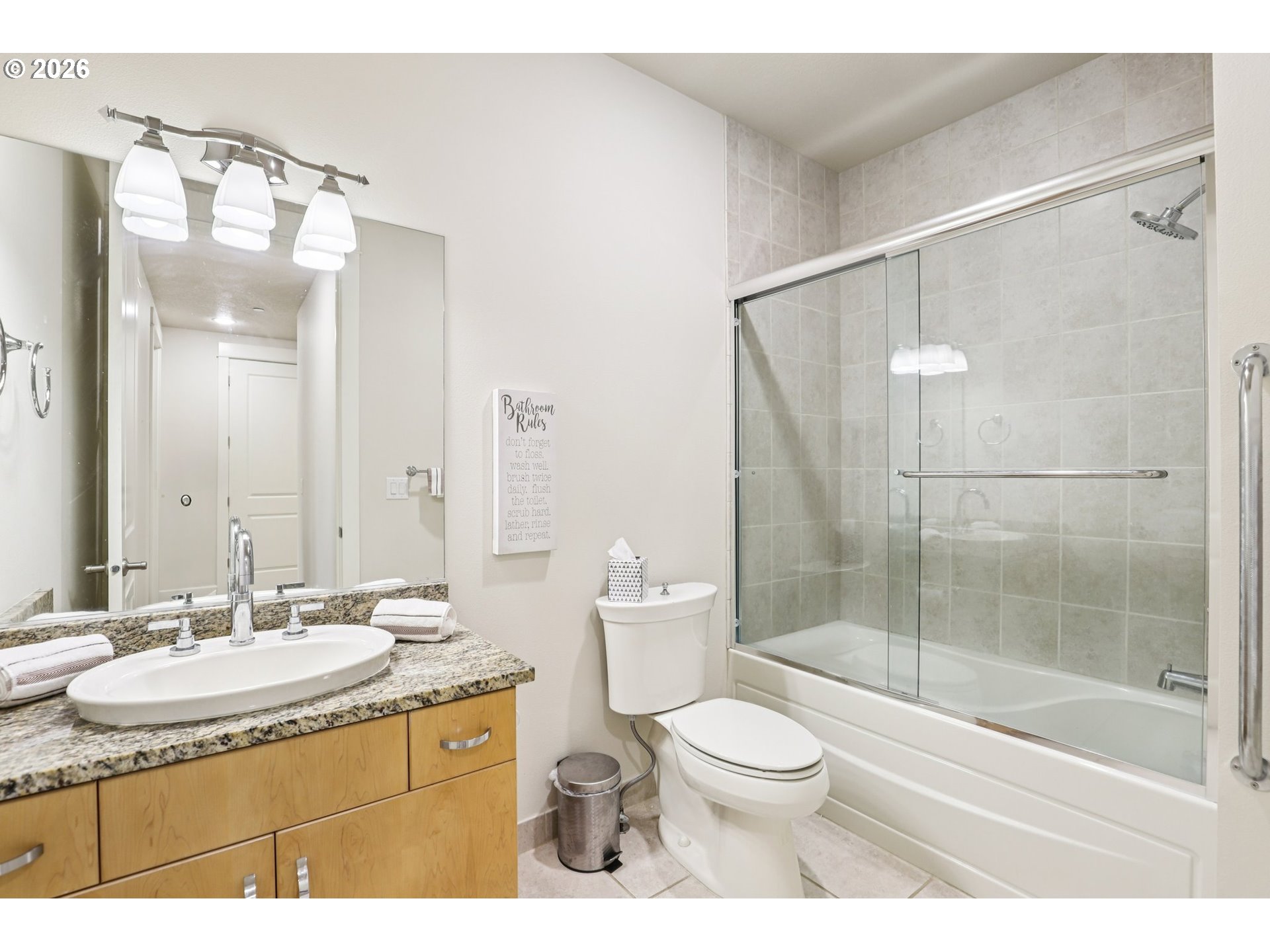 7812 Northwest Quinault Street Camas, WA 98607 - Photo 33 of 48 a bathroom with a granite countertop sink toilet a mirror and shower