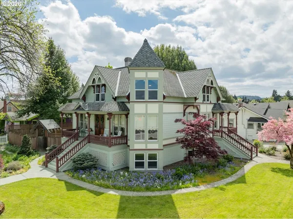 an aerial view of a house with swimming pool and furniture