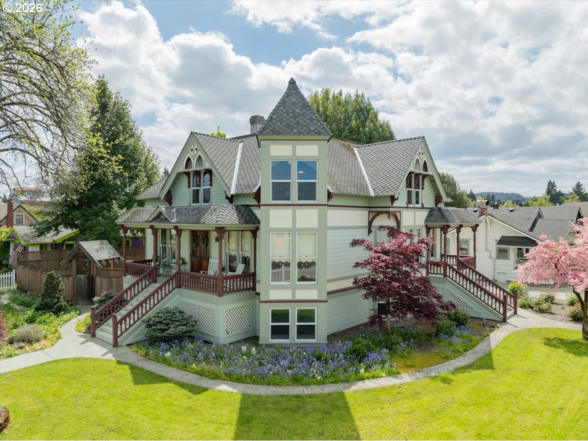 an aerial view of a house with swimming pool and furniture