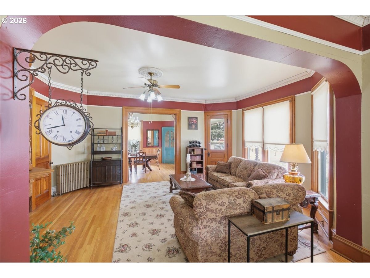 1121 Main Street Dallas, OR 97338 - Photo 12 of 48 a living room with furniture a clock and a large window