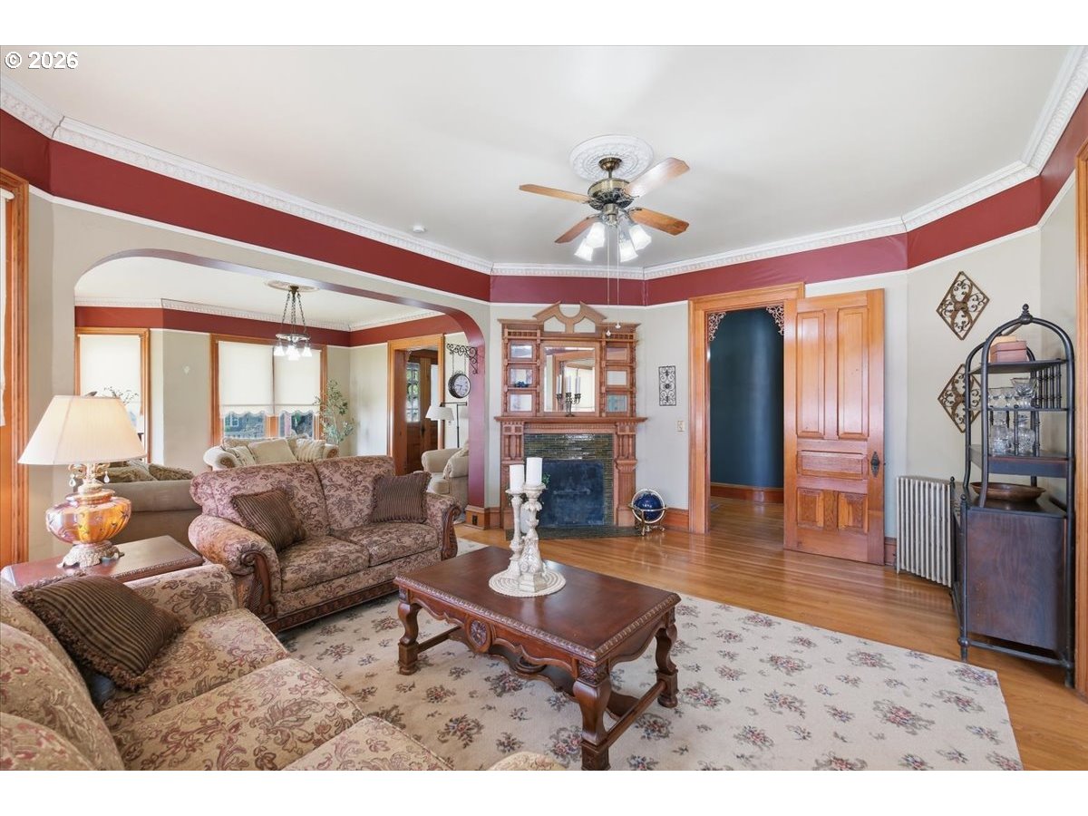 1121 Main Street Dallas, OR 97338 - Photo 13 of 48 a living room with furniture a dining table and large window with wooden floor